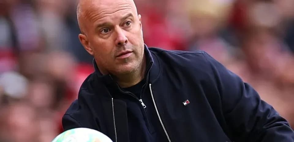 Coach observing the game while holding a ball