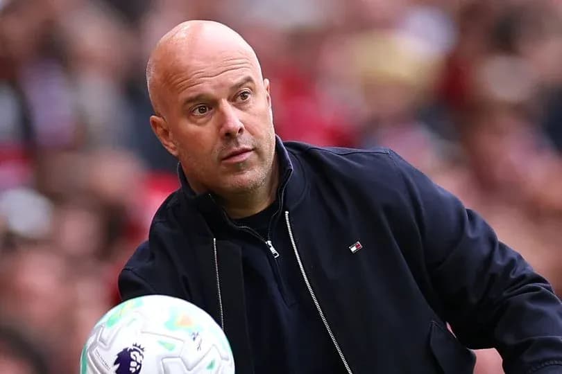 Coach observing the game while holding a ball