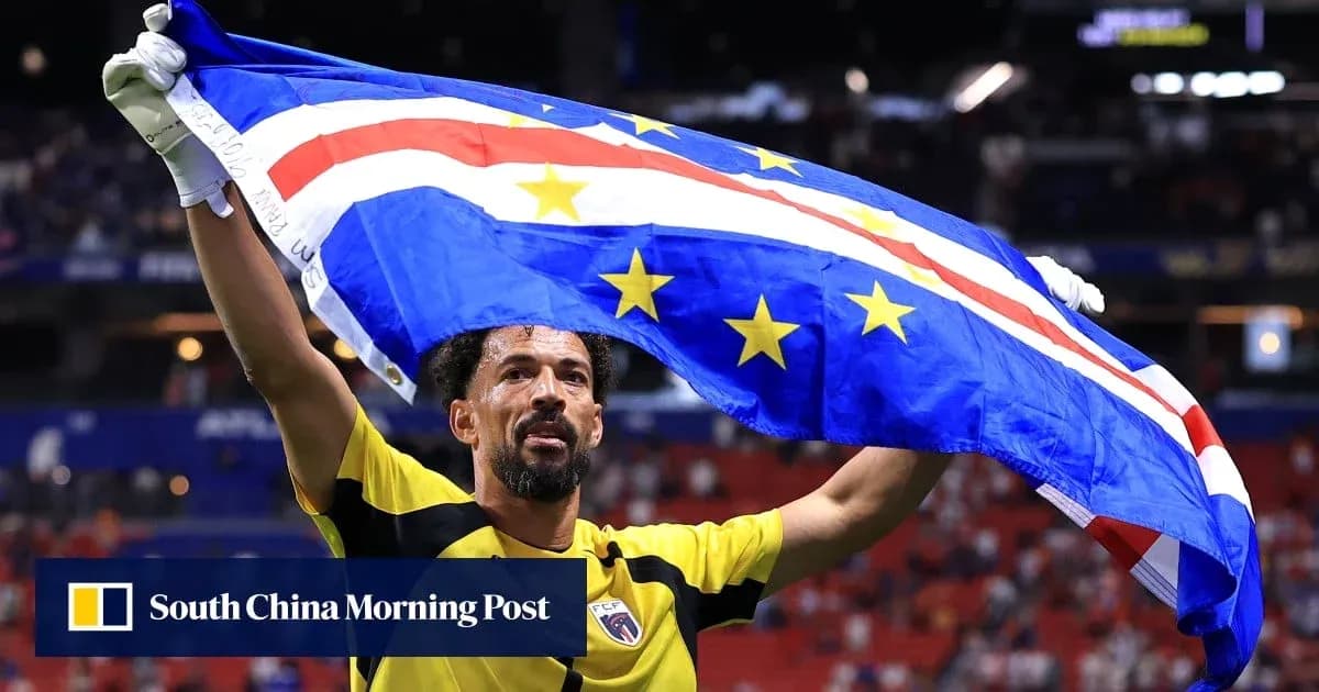 Player celebrating with Cape Verde flag in stadium