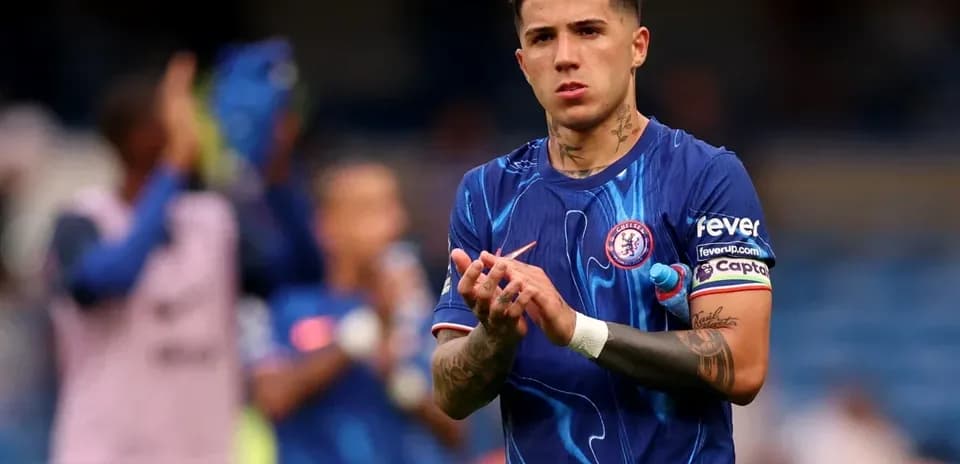 Player applauding fans in Chelsea kit on pitch