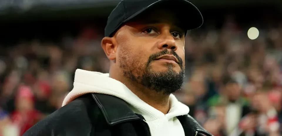 Man wearing a black cap and jacket at stadium