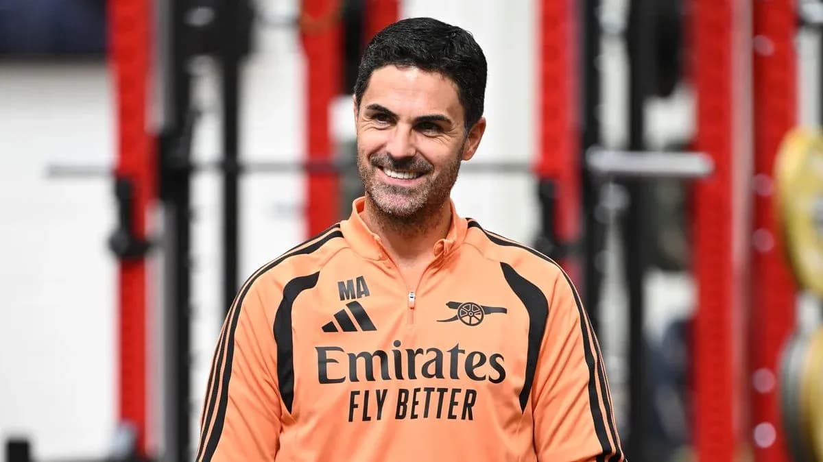 Arsenal manager in training facility smiling