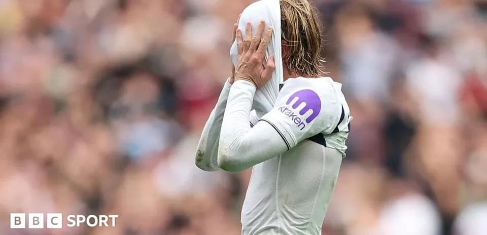 Player covering face with jersey during match
