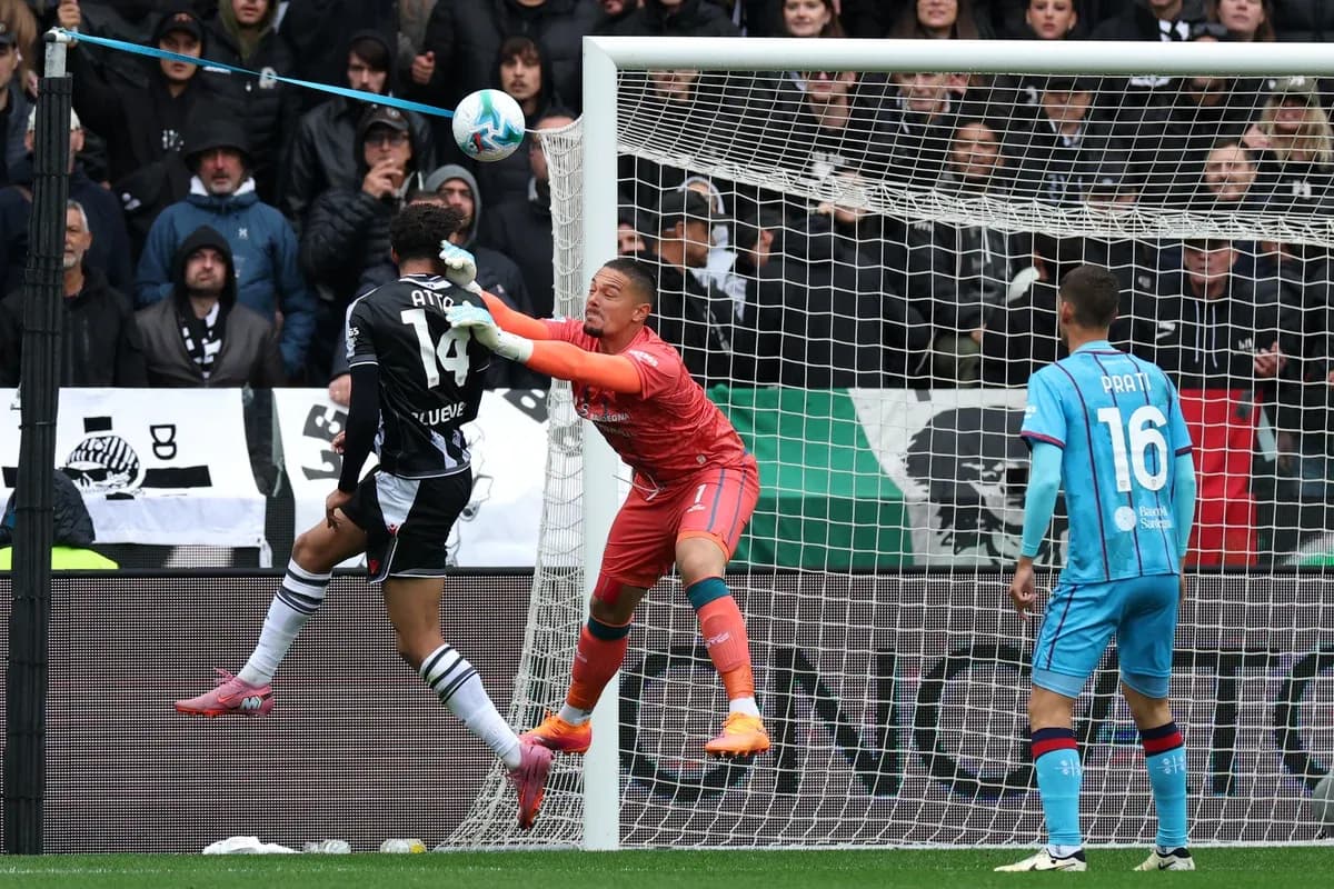 Goalkeeper attempts to block a shot during match