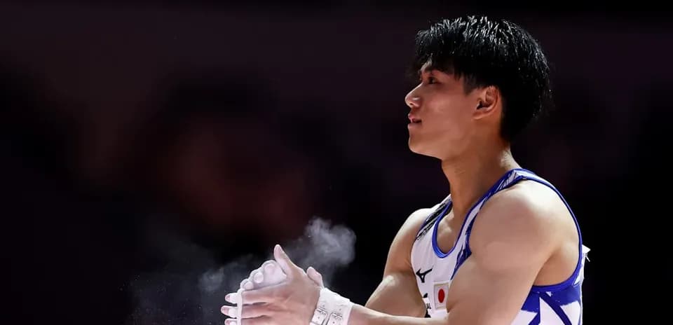Gymnast applying chalk to hands before routine