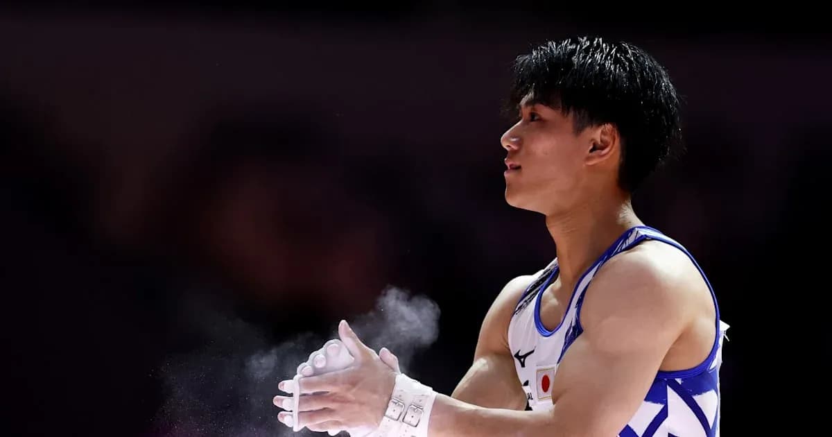 Gymnast applying chalk to hands before routine