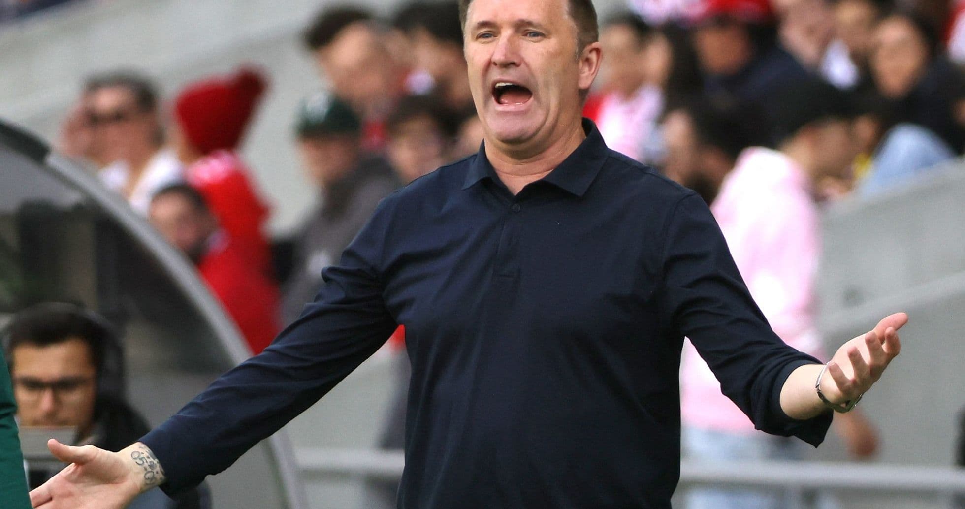 Coach gesturing and directing players during match