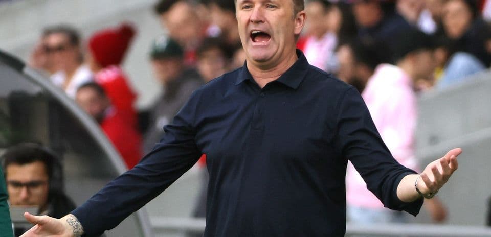 Coach gesturing and directing players during match