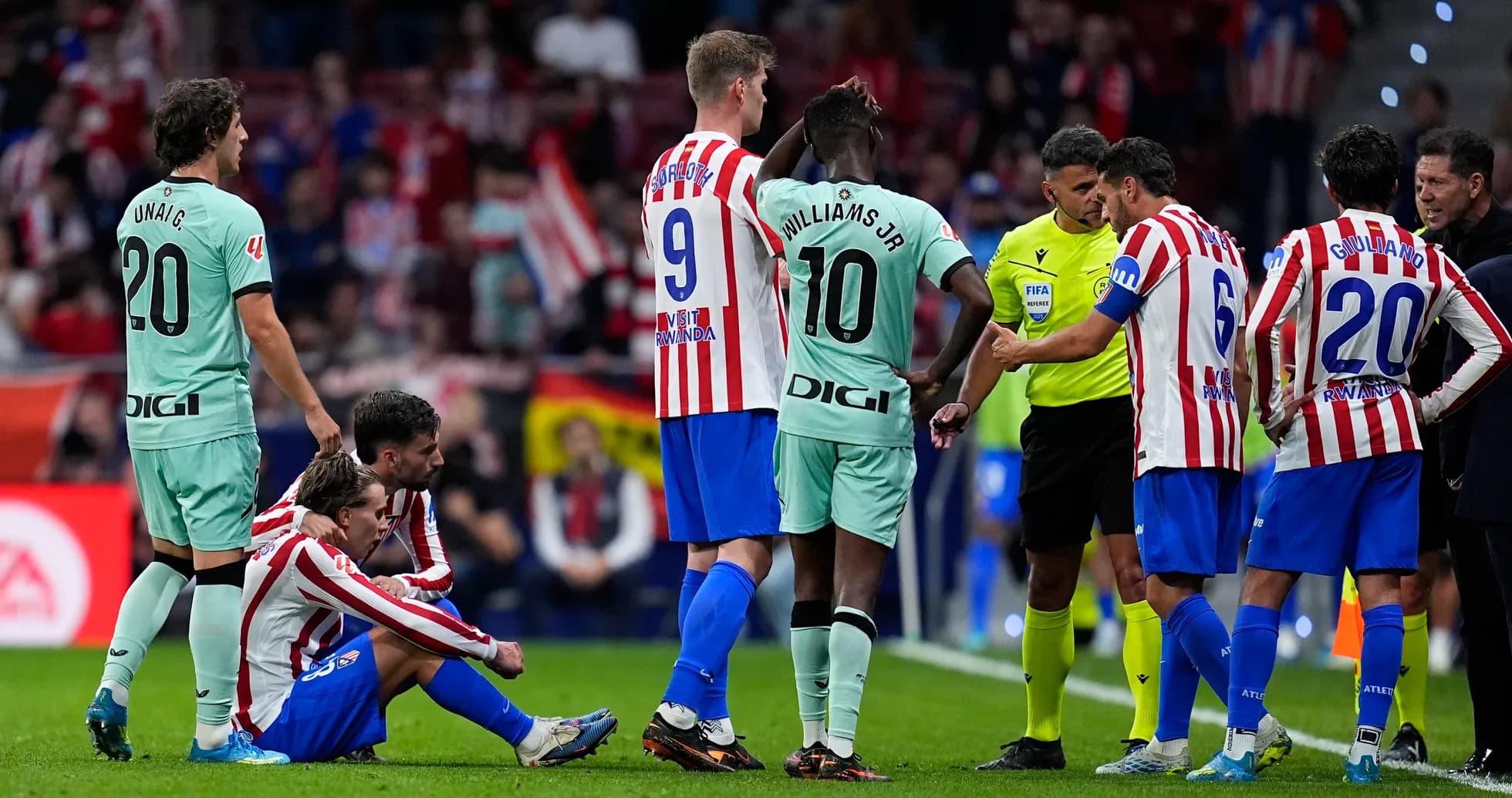 Atletico Madrid players discussing with the referee