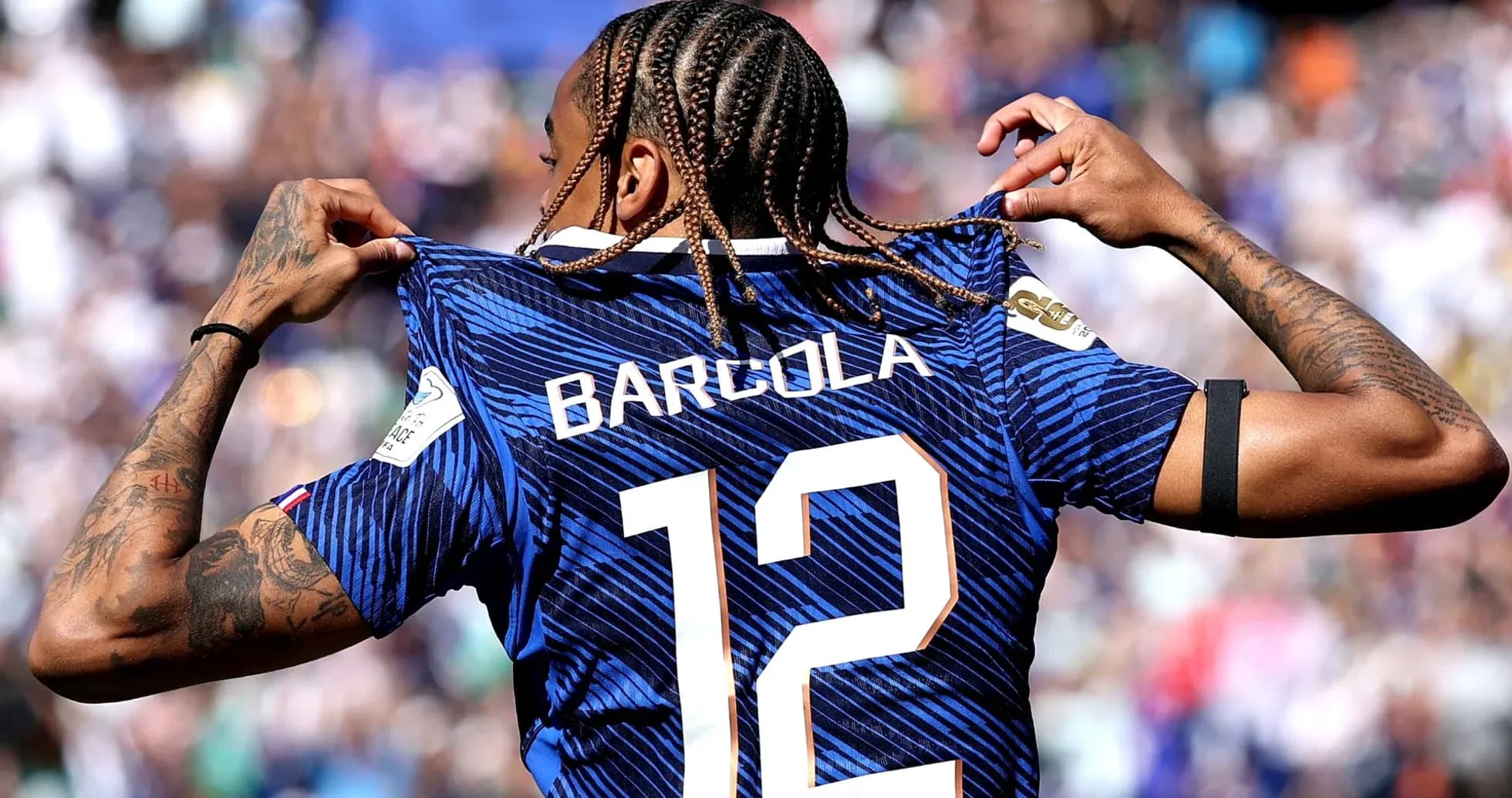 Player displaying jersey with name and number