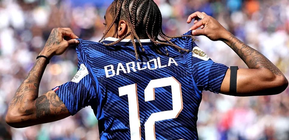 Player displaying jersey with name and number