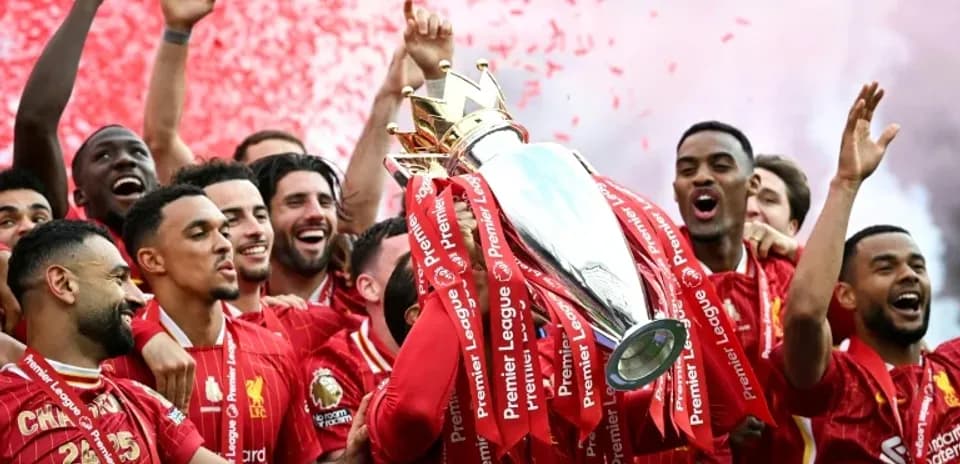 Liverpool players celebrating with Premier League trophy