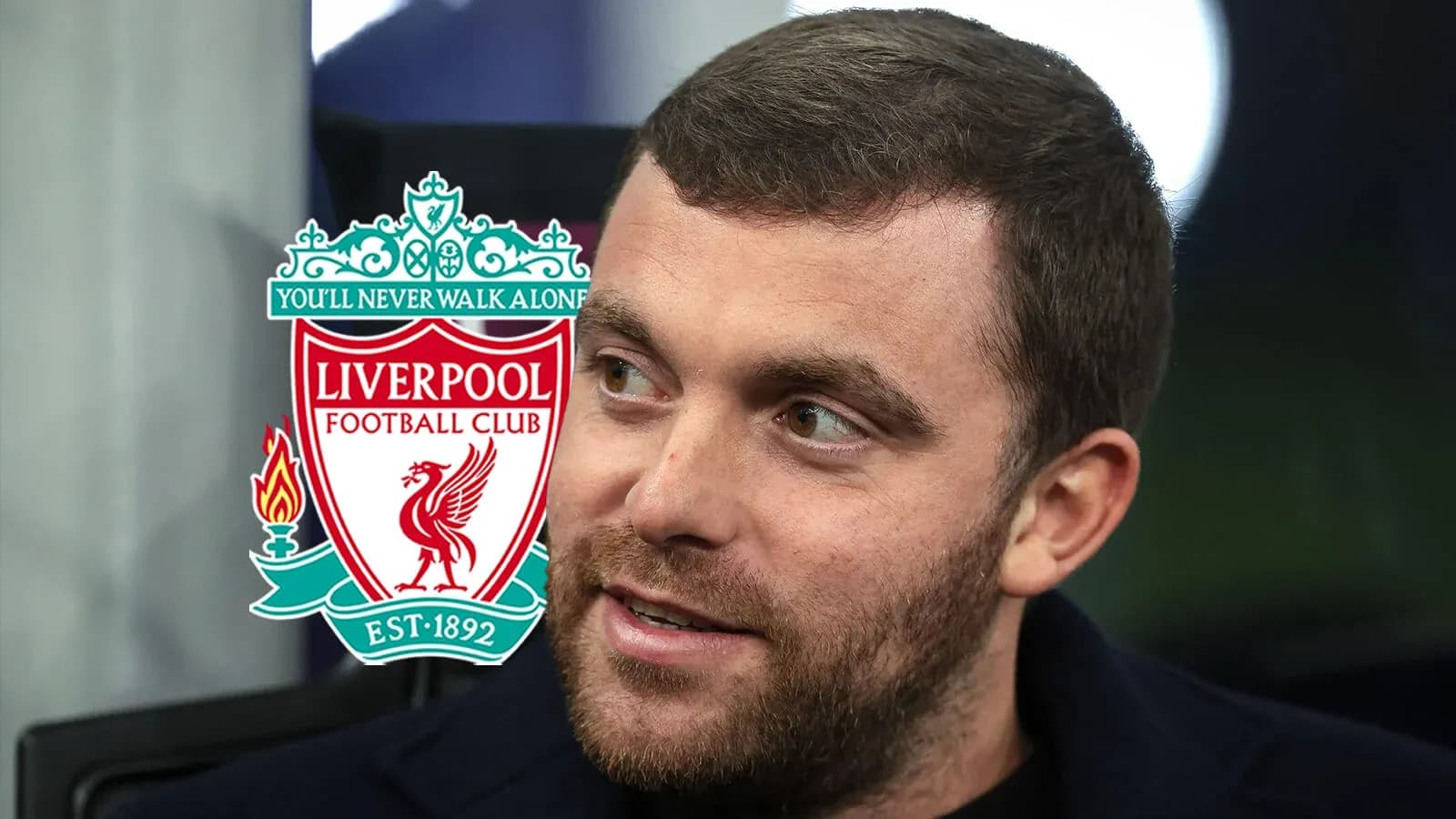 Man with beard next to Liverpool FC logo