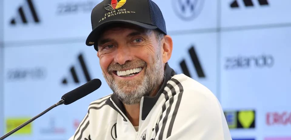 Manager speaking at press conference with microphone