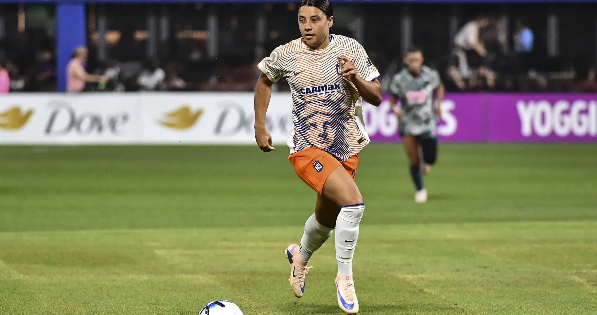 Player sprinting with ball during soccer match