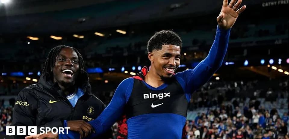 Two players celebrating on the pitch after match