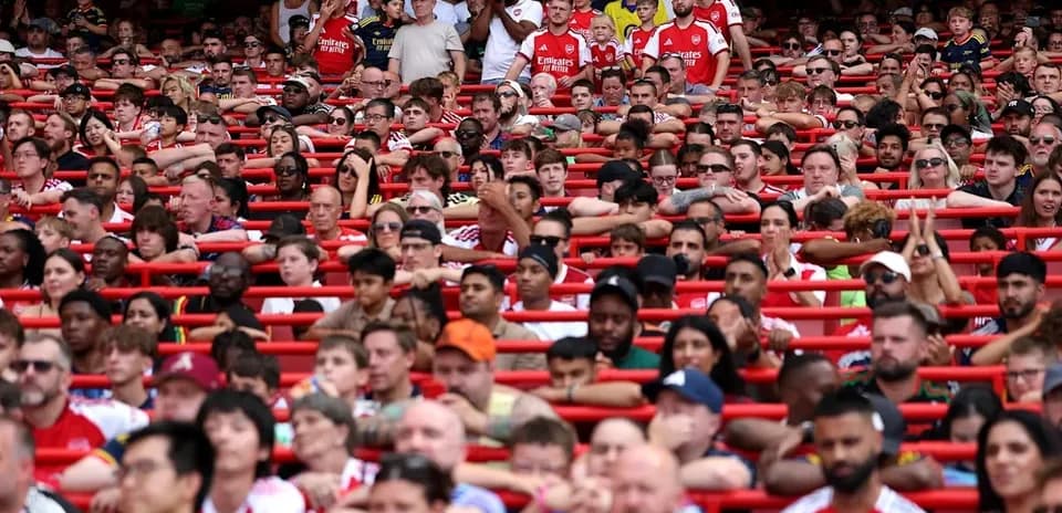 Crowd of Arsenal fans in stadium seating