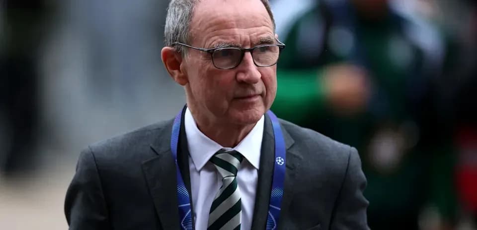 Man in suit with glasses walking towards camera