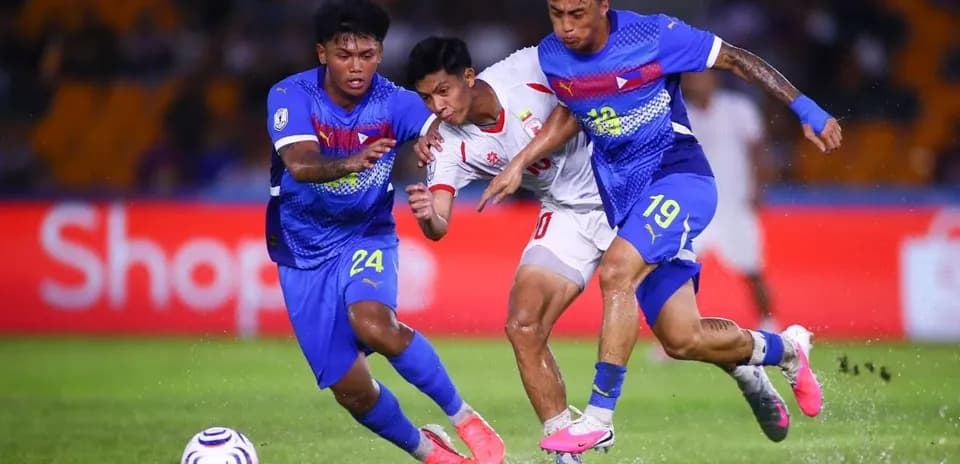 Players contesting the ball during a football match