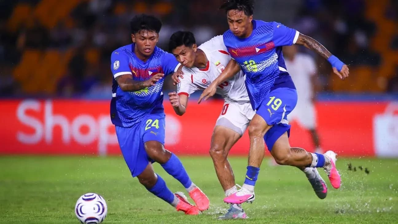 Players contesting the ball during a football match
