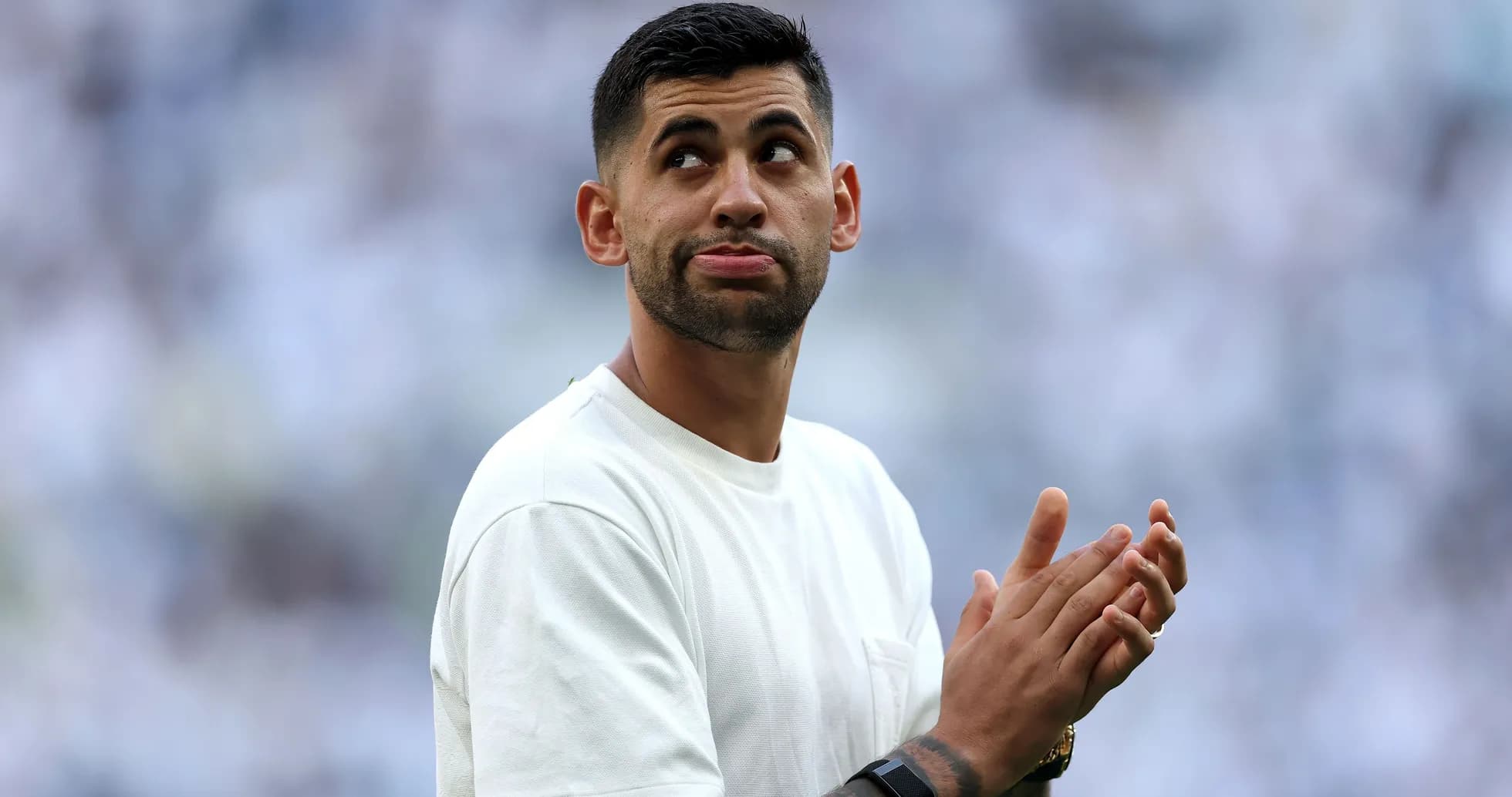 Player clapping in a stadium before a match