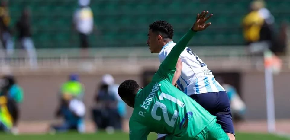 Player tackling opponent during CAF Champions League match