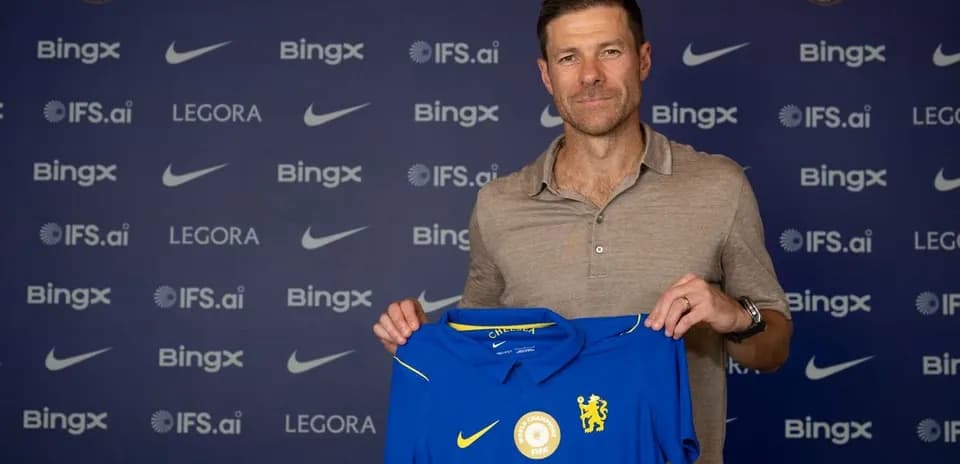New coach holding Chelsea FC jersey at announcement