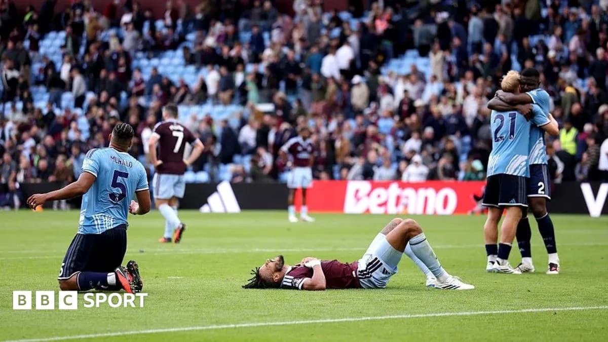 Players reacting after match, one on the ground