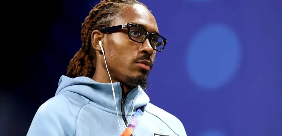 Player wearing glasses and earphones, focused