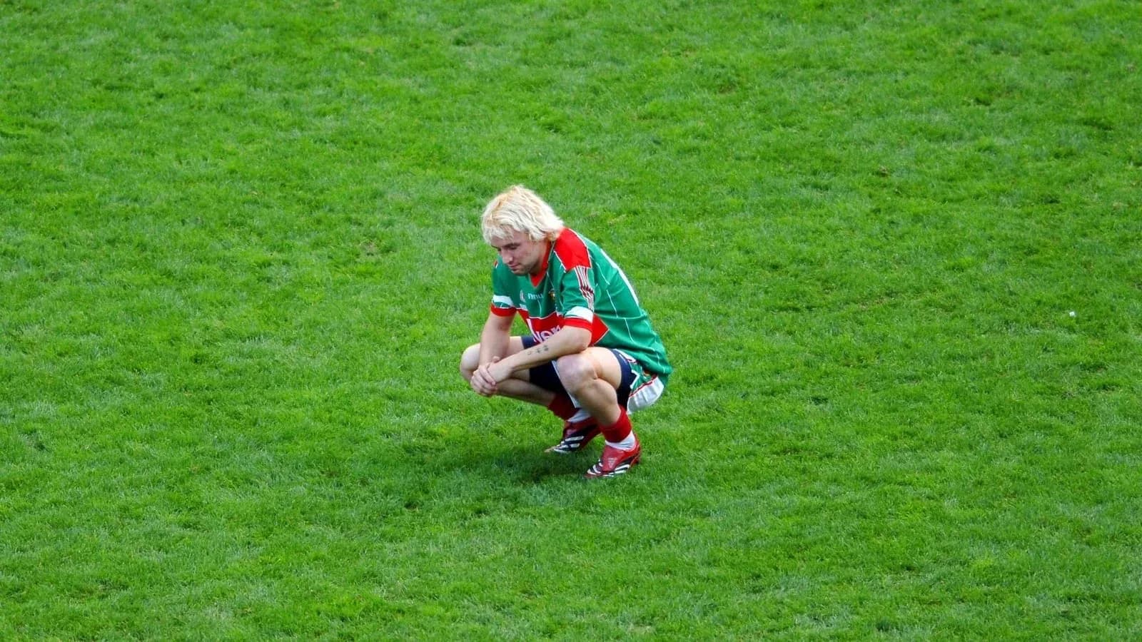 Player squatting on the field during a match