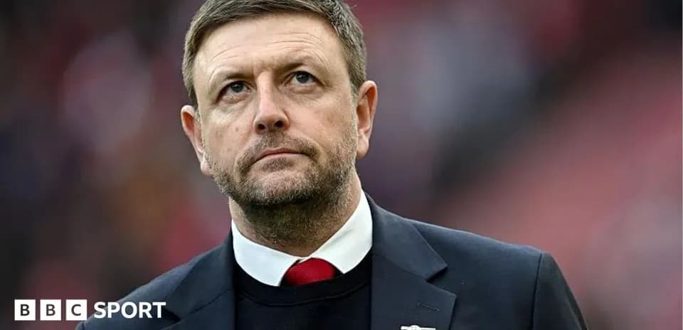 Man in suit looking upwards during match