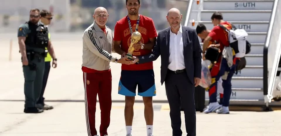 Player receiving trophy at arrival airport ceremony