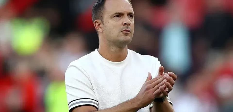 Coach applauding during match on sidelines