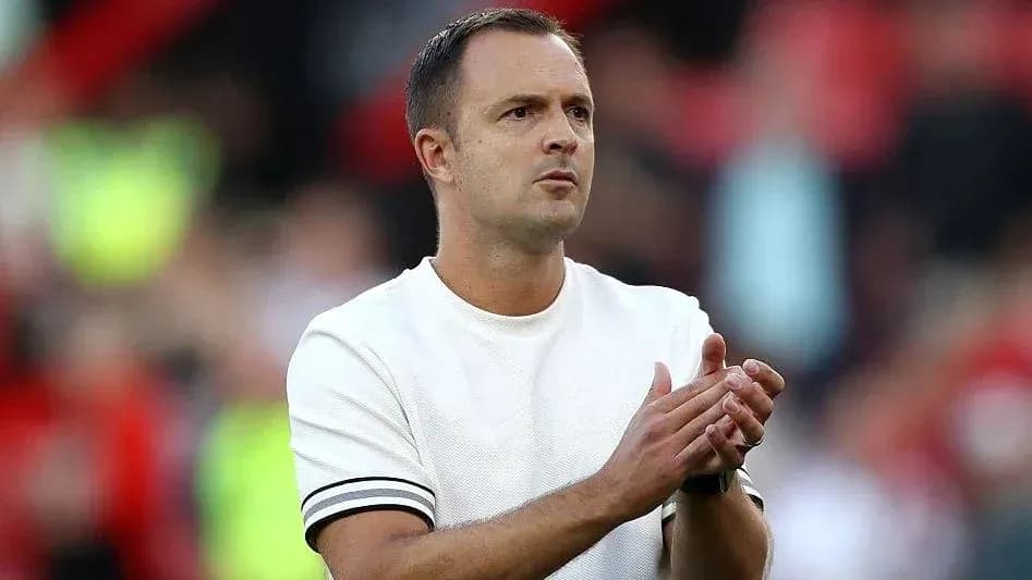 Coach applauding during match on sidelines