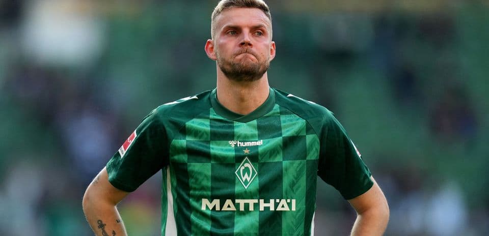 Player in green jersey standing on the field