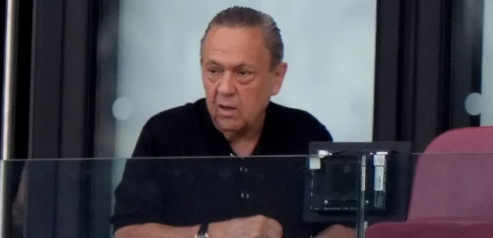 Man observing from a box at a stadium