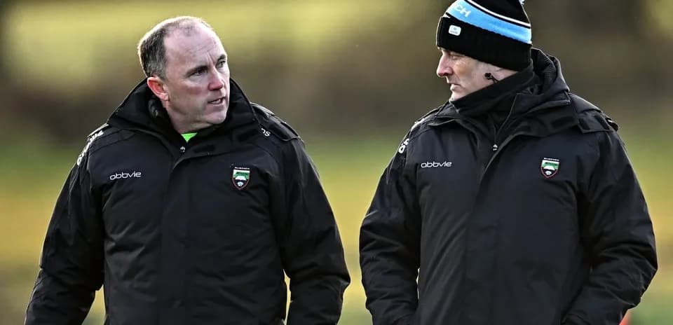 Two coaches discussing on training field