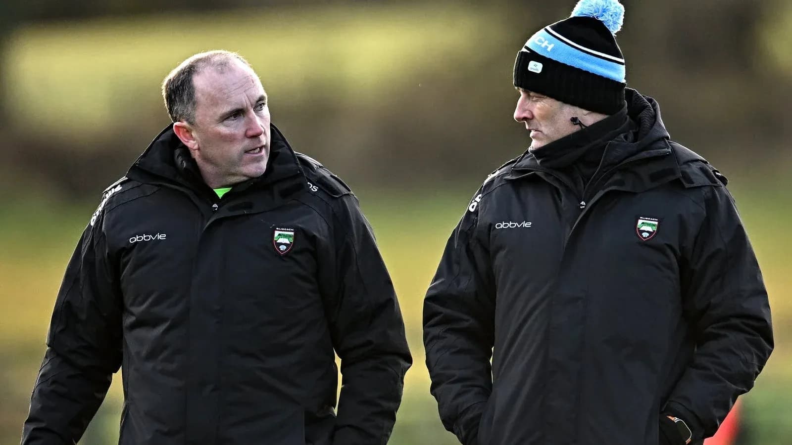 Two coaches discussing on training field