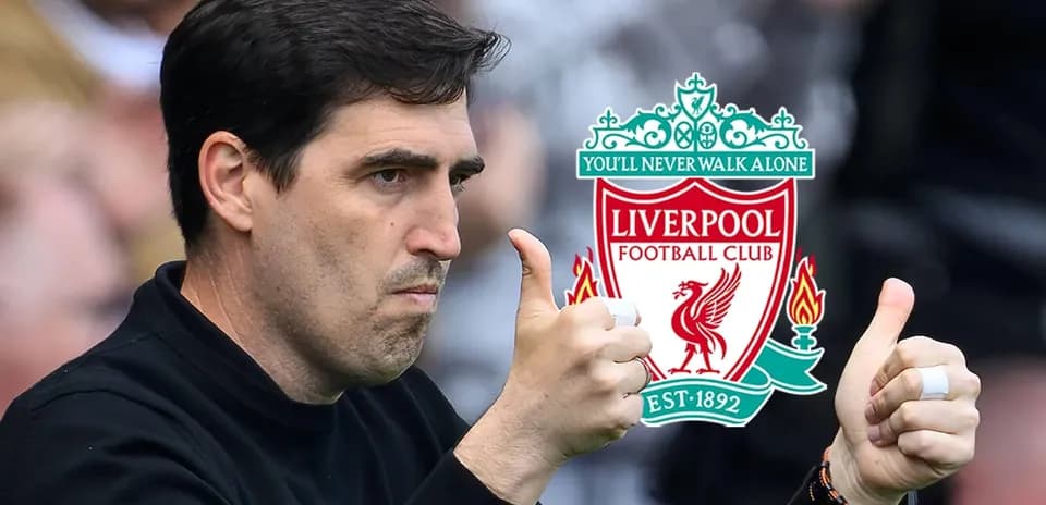 Coach giving thumbs up with Liverpool logo