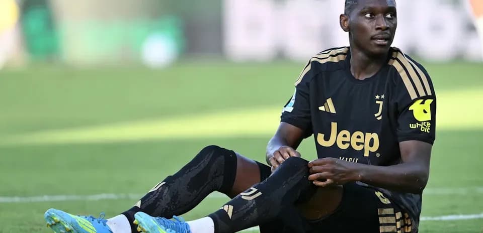 Juventus player sitting on field during match
