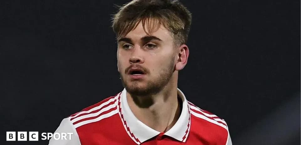 Player wearing Arsenal jersey during match action