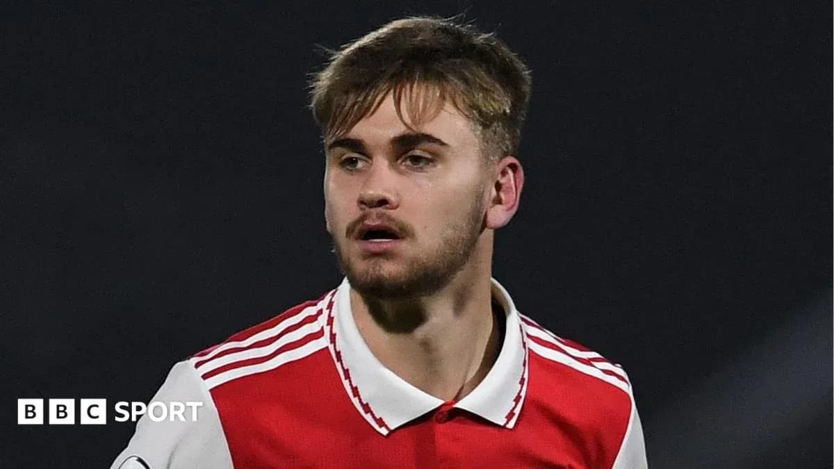 Player wearing Arsenal jersey during match action