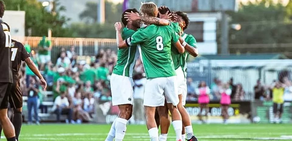 Players celebrating a goal on the pitch