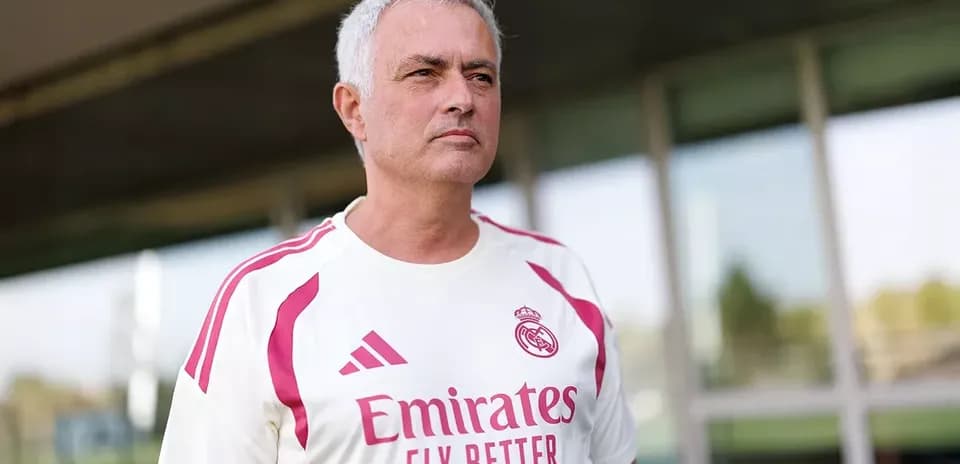 Coach wearing Real Madrid training kit outdoors