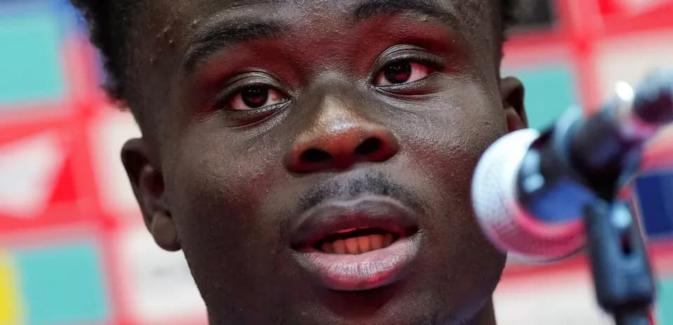 Player speaking at a press conference with microphone
