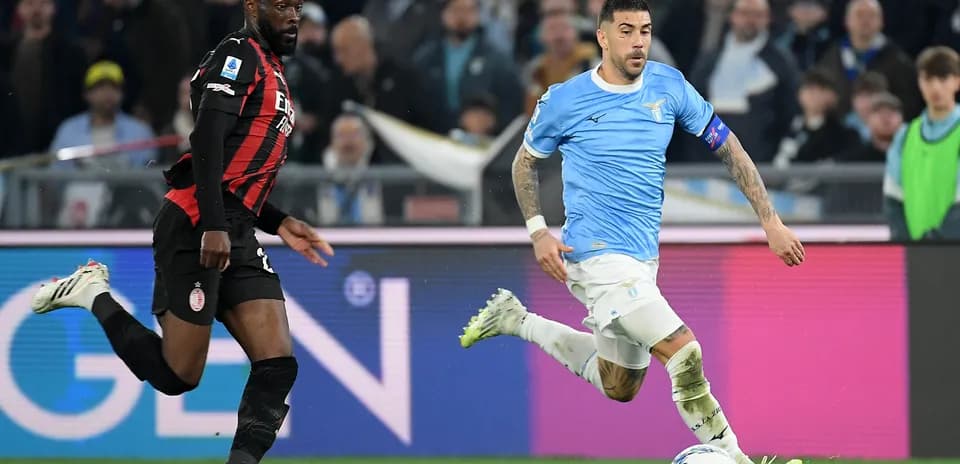 Lazio player dribbling past AC Milan defender