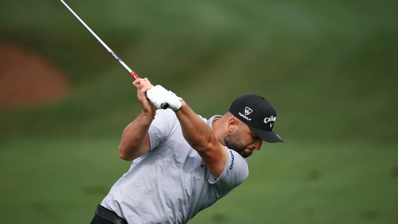 Golfer swinging club on the course