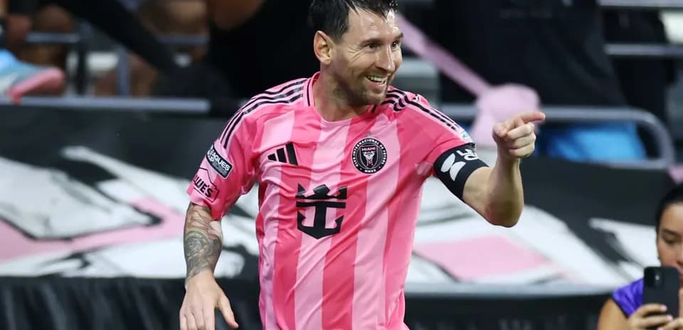 Player celebrating in pink jersey during match