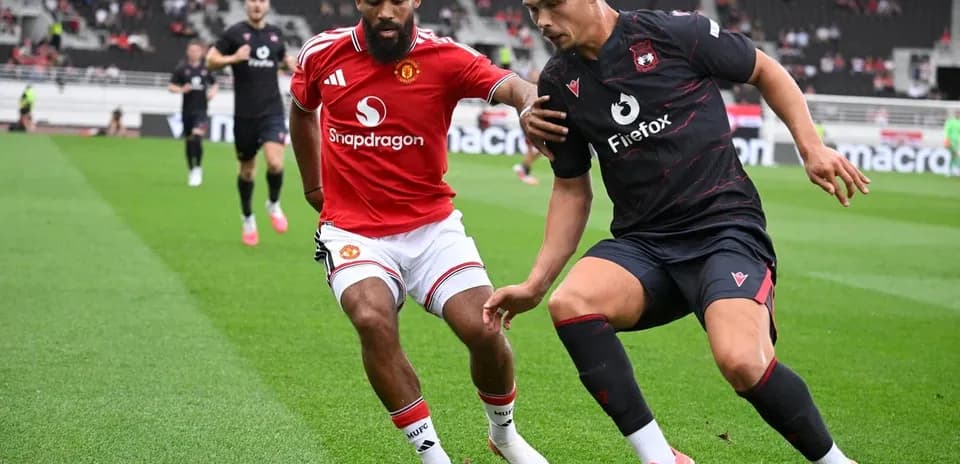 Two players competing for the ball on the field