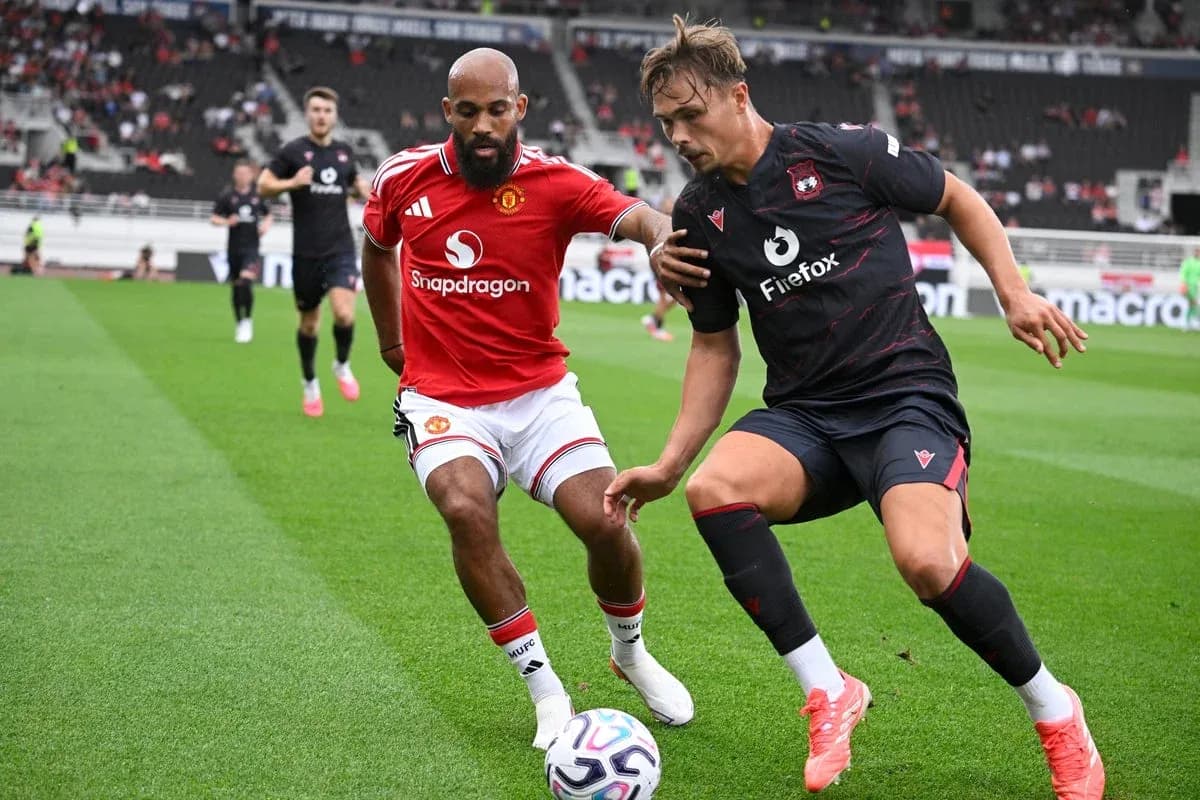 Two players competing for the ball on the field